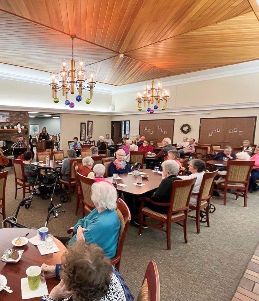 group of elders in the dining area with food and drinks