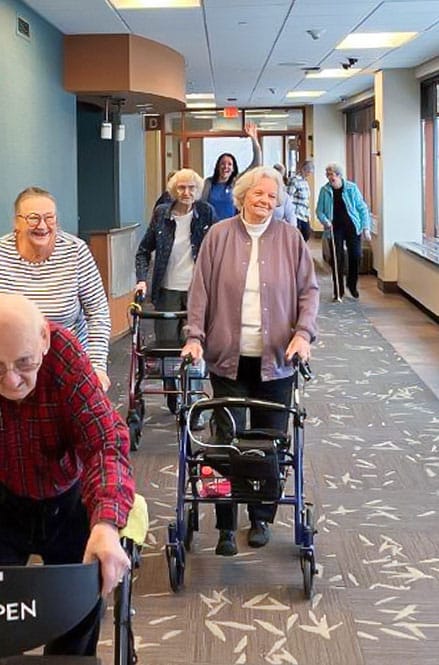 residents walking in hallway for heart walk