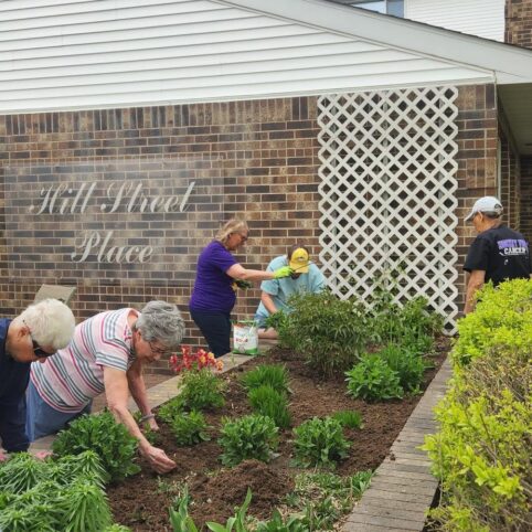 group of tenants gardening at hill street place