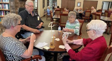 tenants playing open 500 card game in common area