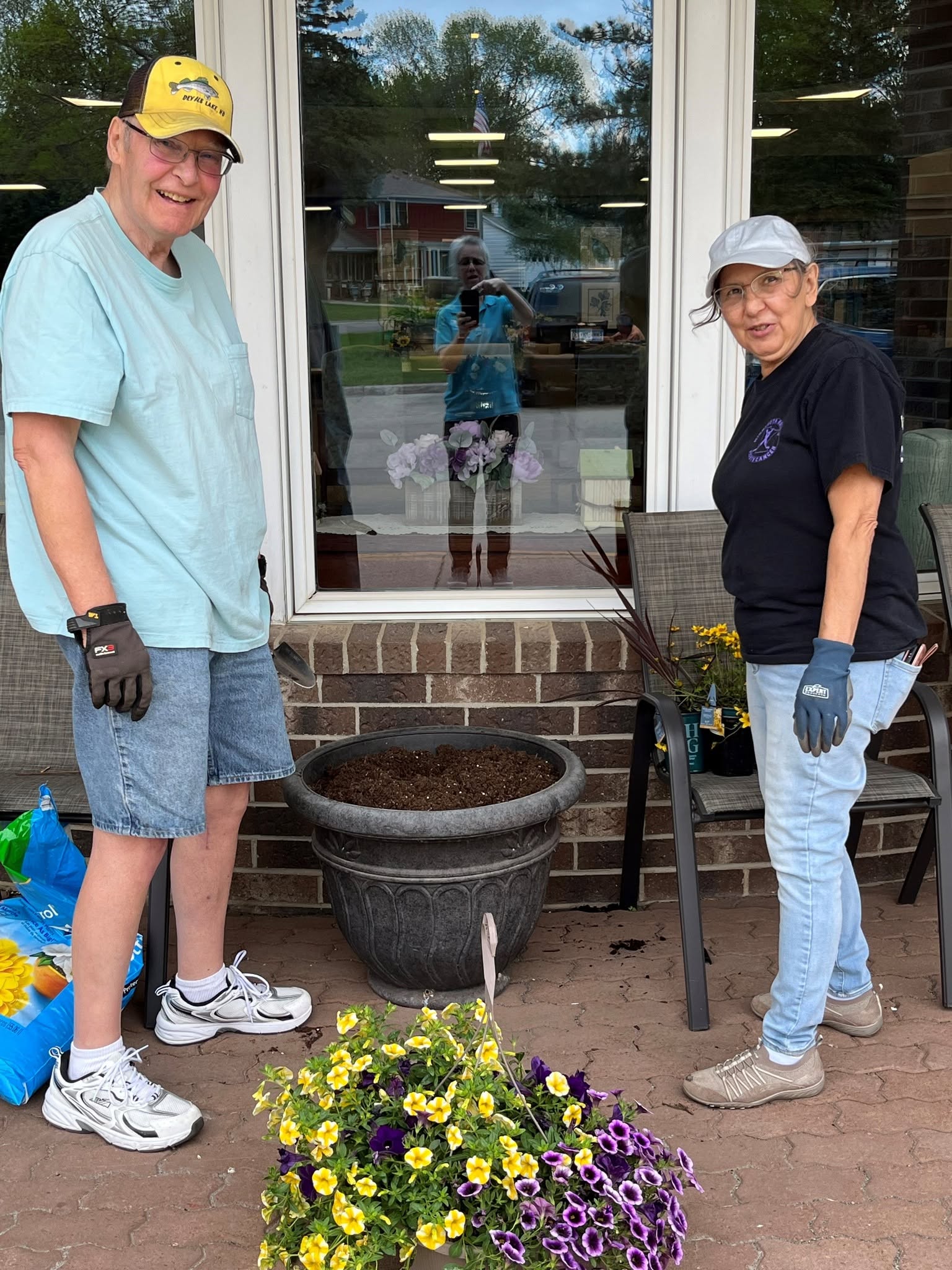 male tenant planting flowers in pot