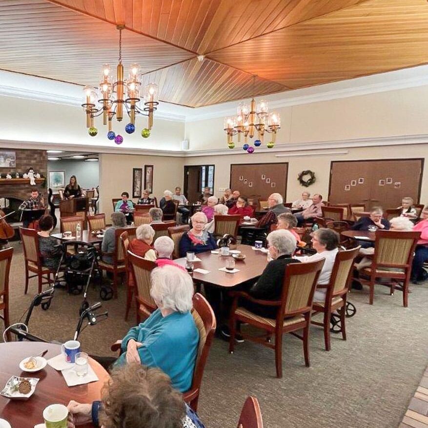 group of elders in the dining area with food and drinks