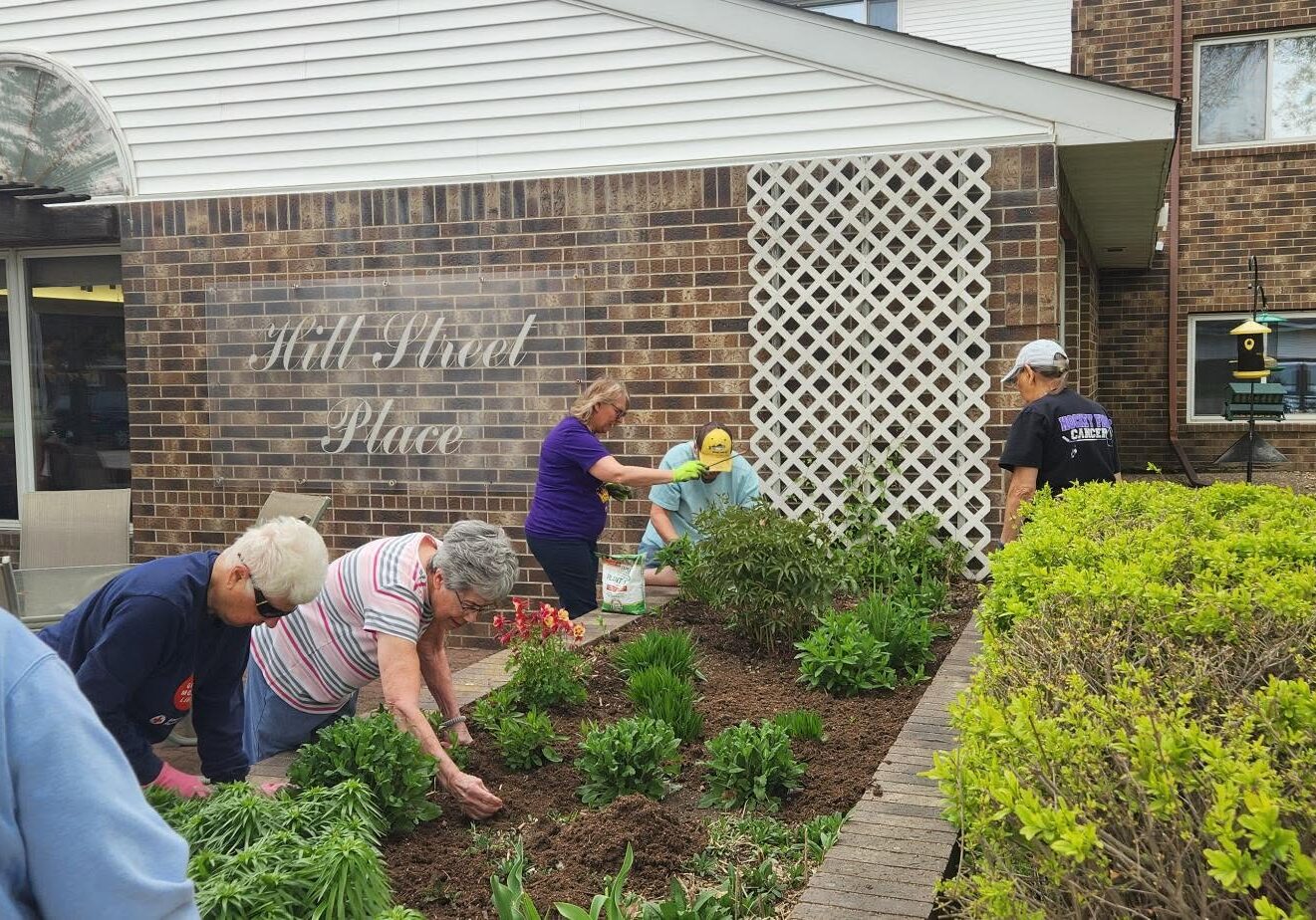 group of tenants gardening at hill street place