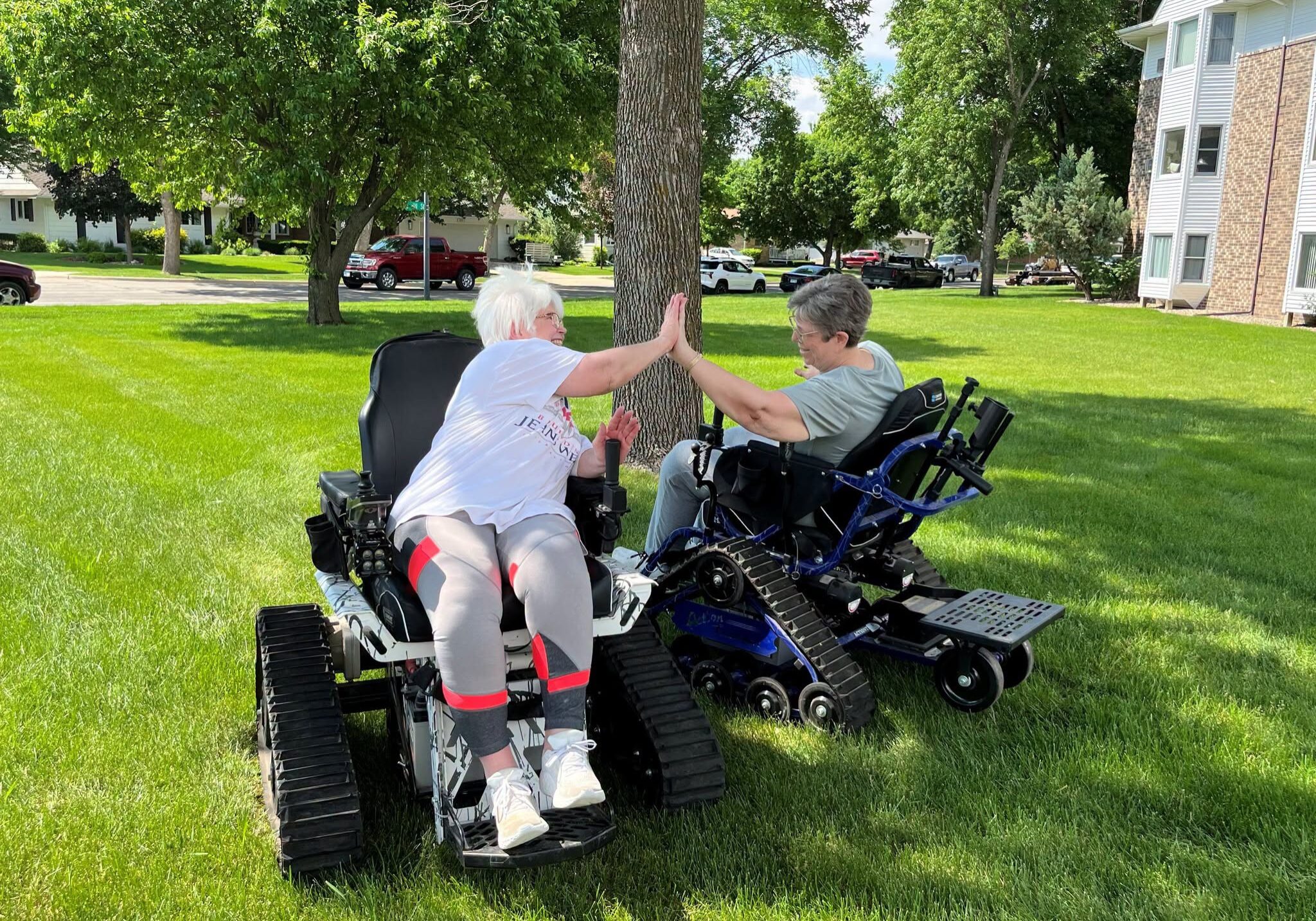 tenants high fiving each other in fun chairs