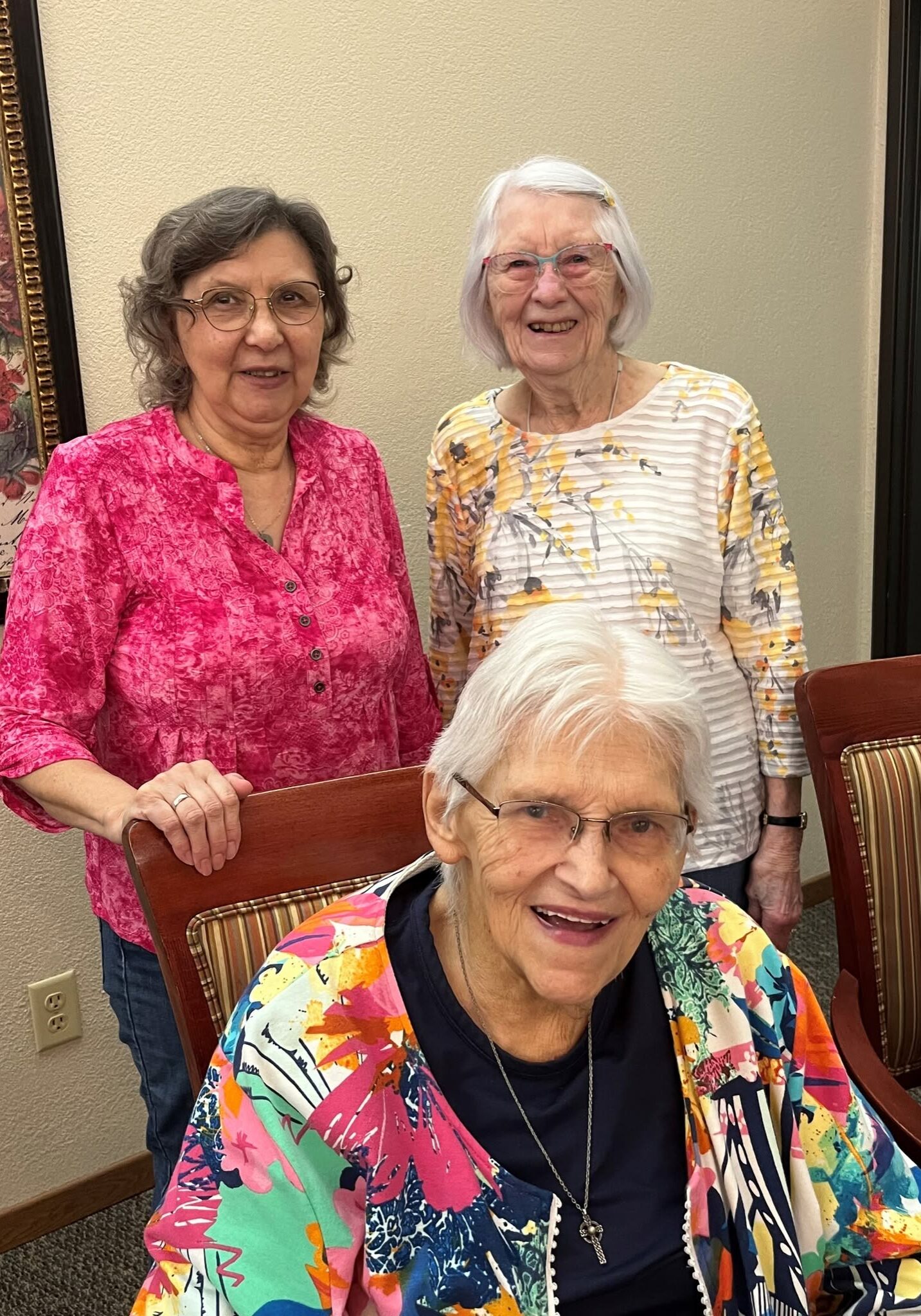 three women standing together smiling at Hill Street Place